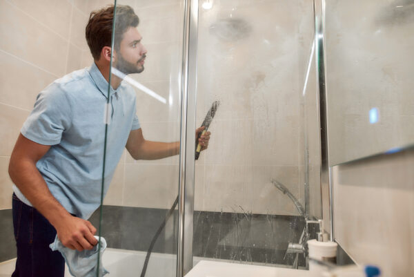 A professional technician performing deep shower cleaning using advanced tools to remove grime and stains from glass and tiles in San Pedro, CA.