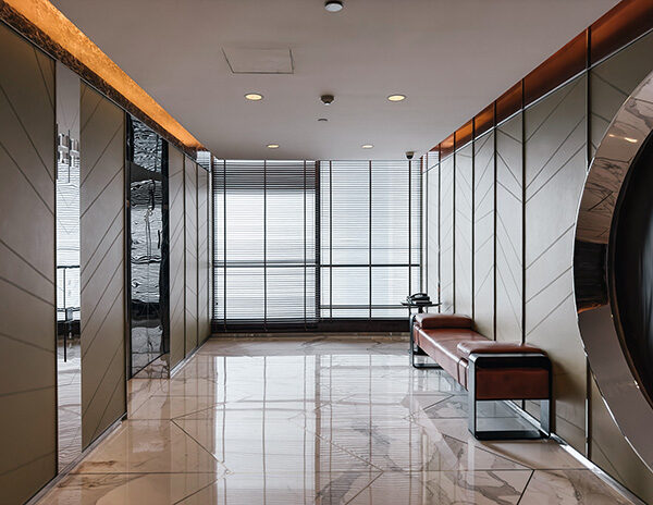 High-gloss stone floor after professional sealing in a modern hallway