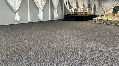 Freshly cleaned carpet in a large home or event space, showcasing professional carpet cleaning services