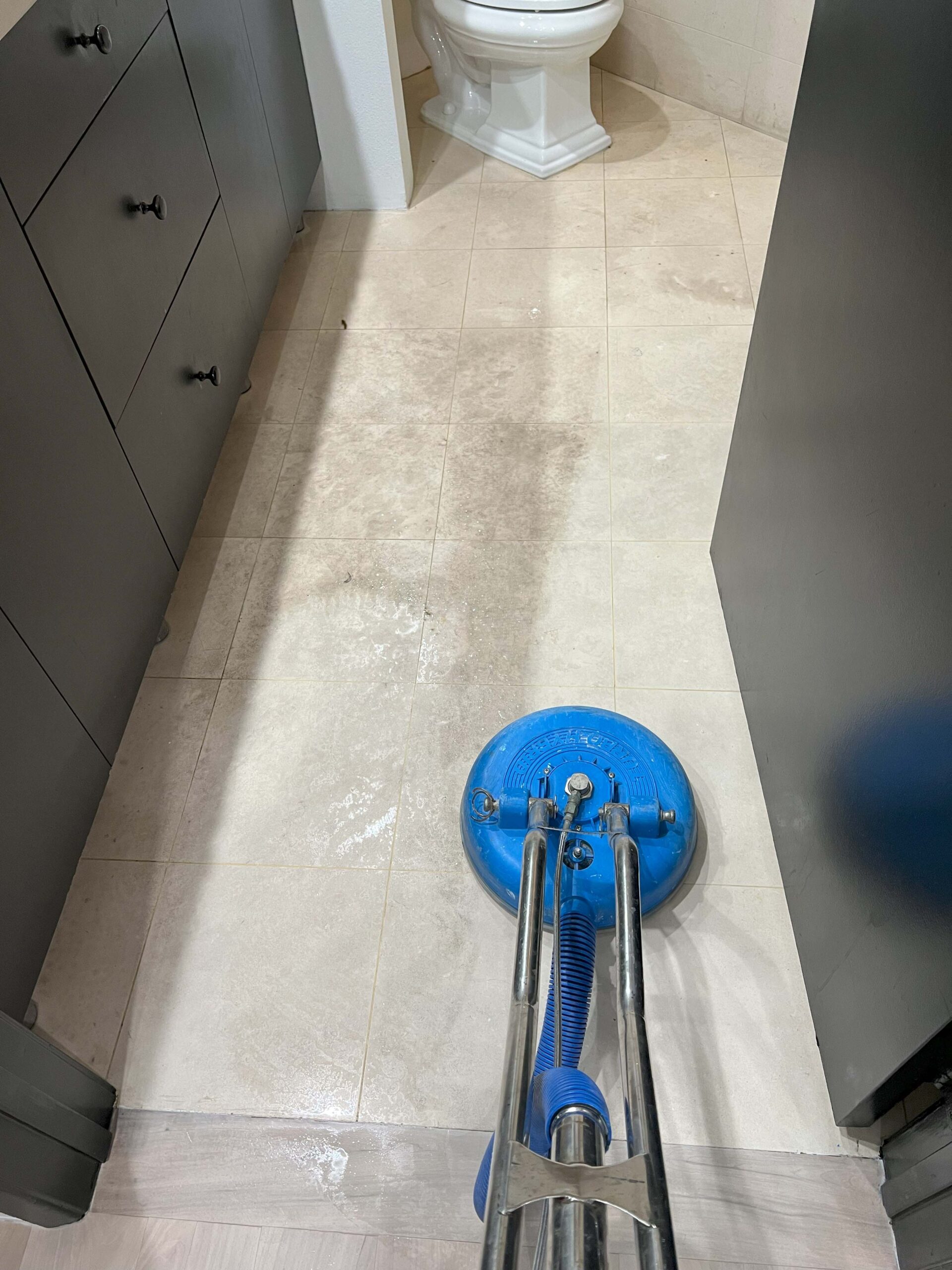 San Pedro tile floor being cleaned during water damage restoration