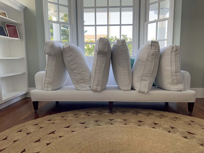 White couch with cushions removed for professional allergy-focused carpet & upholstery cleaning
